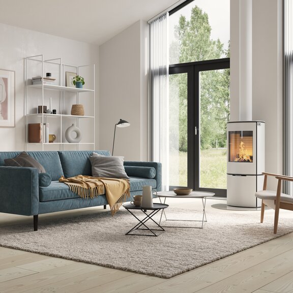 Poêle à bois CARO 110 en blanc avec porte en acier dans une atmosphère moderne et lumineuse