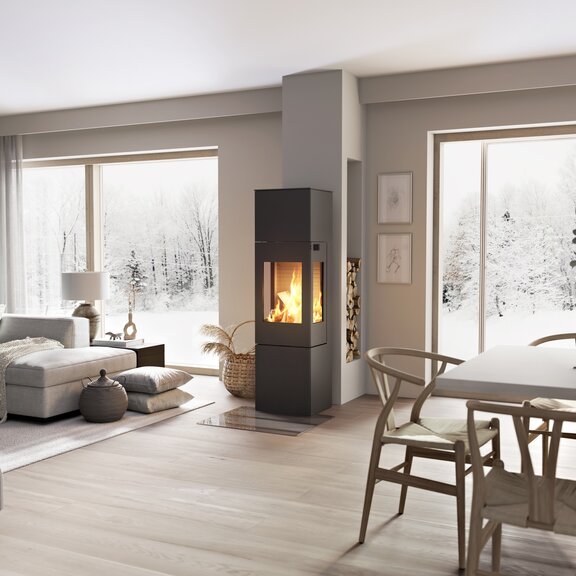 Poêle à bois NEXO 160 en noir avec porte en acier et vitres latérales au milieu de la pièce à vivre entre la salle à manger et le salon
